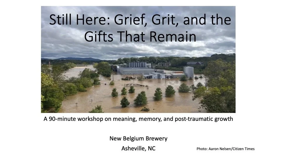 Flooded industrial area with water covering the ground and surrounding trees, under a cloudy sky at the New Belgium Brewery in Asheville, North Carolina.