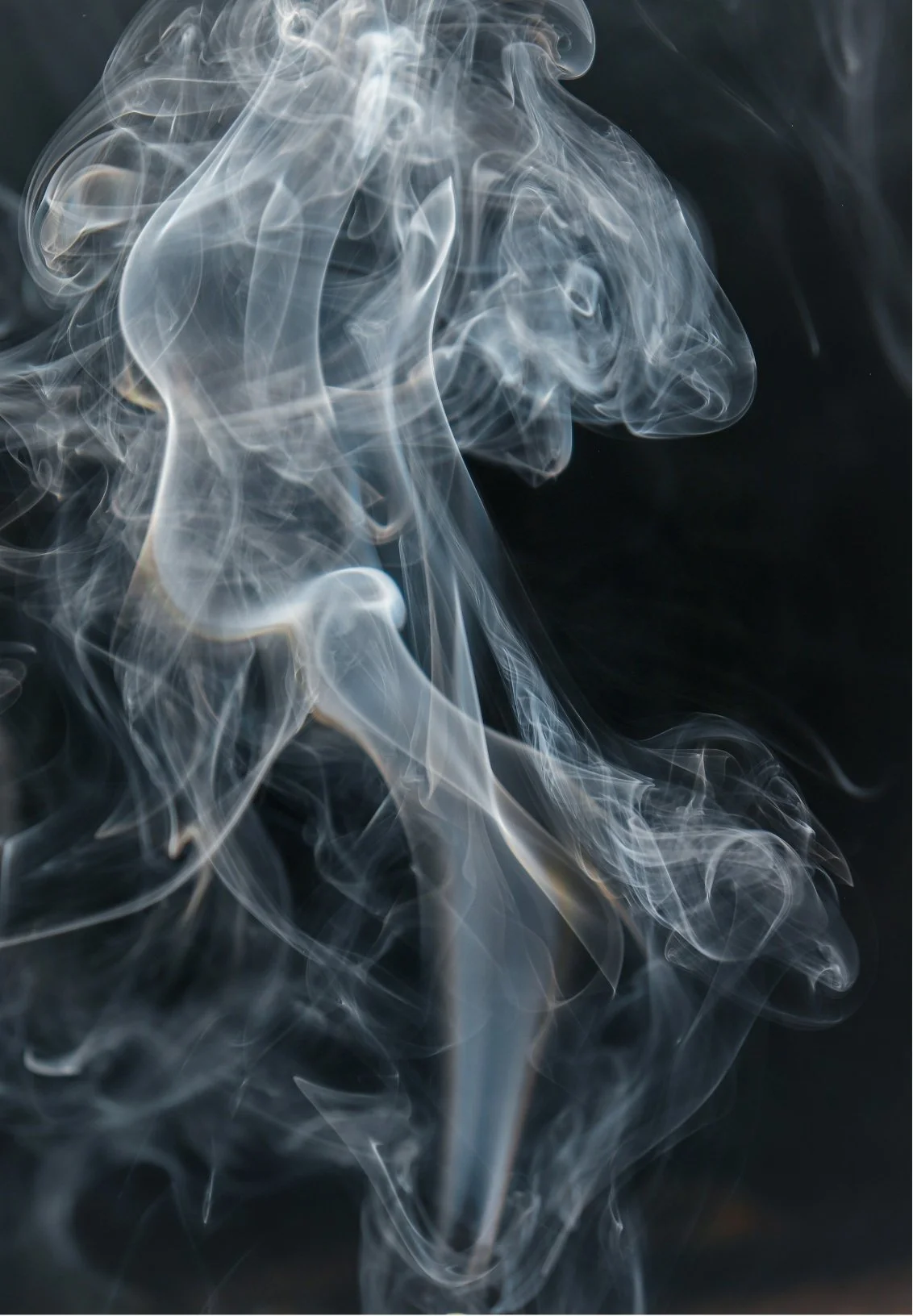 Swirling white smoke against a dark background.