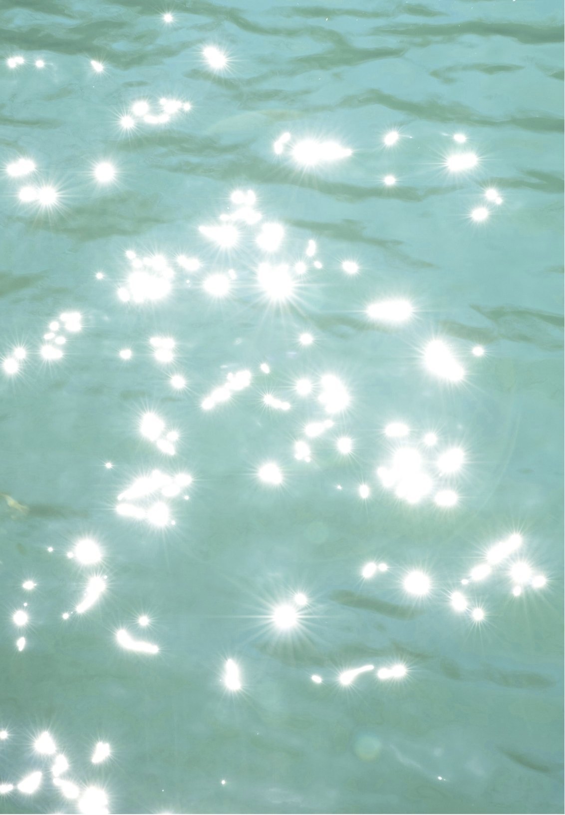 Sunlight reflecting off a body of water with sparkling highlights.
