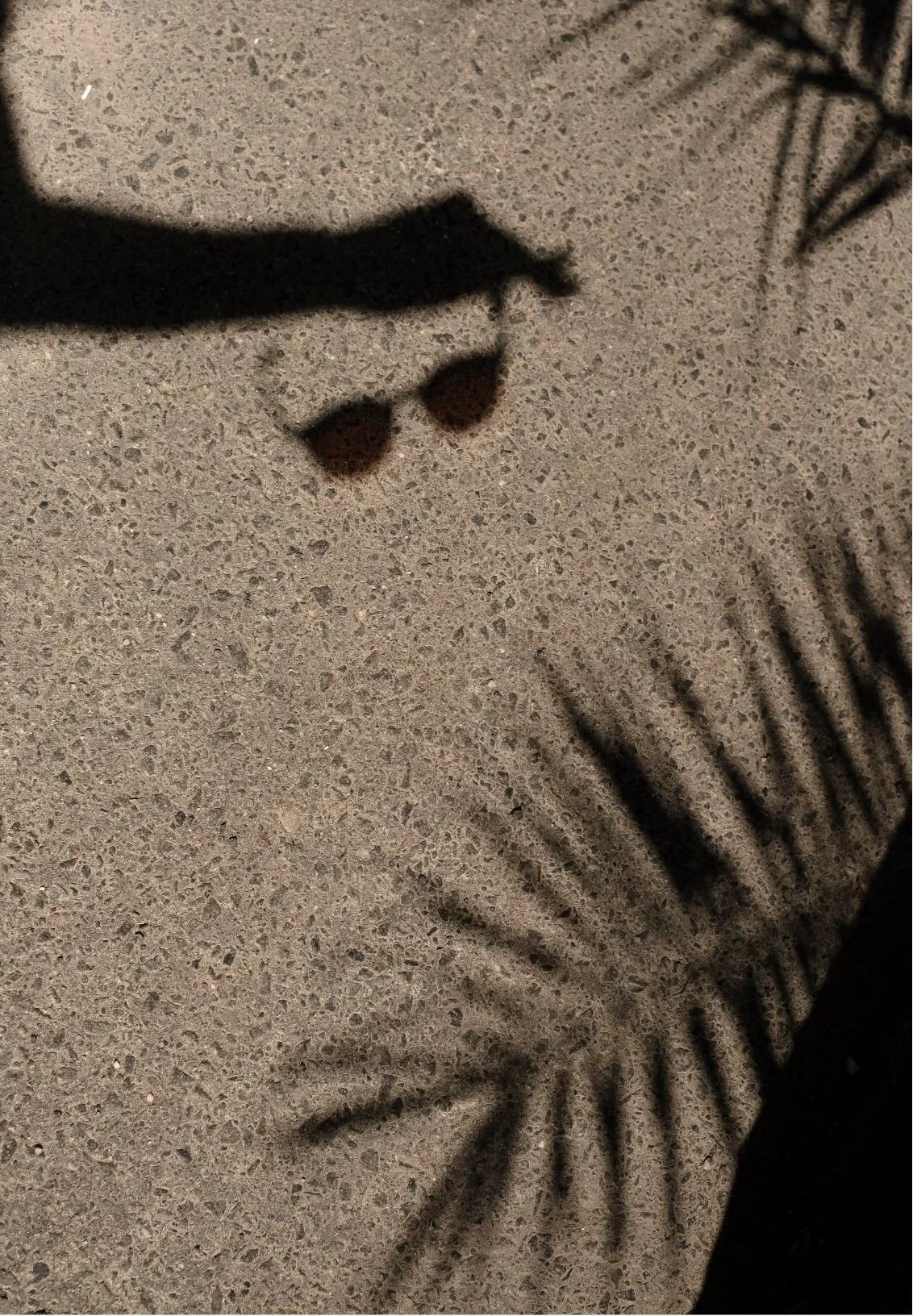 Close-up of a clock face with black hour and minute hands, a textured surface background, and black numbers.