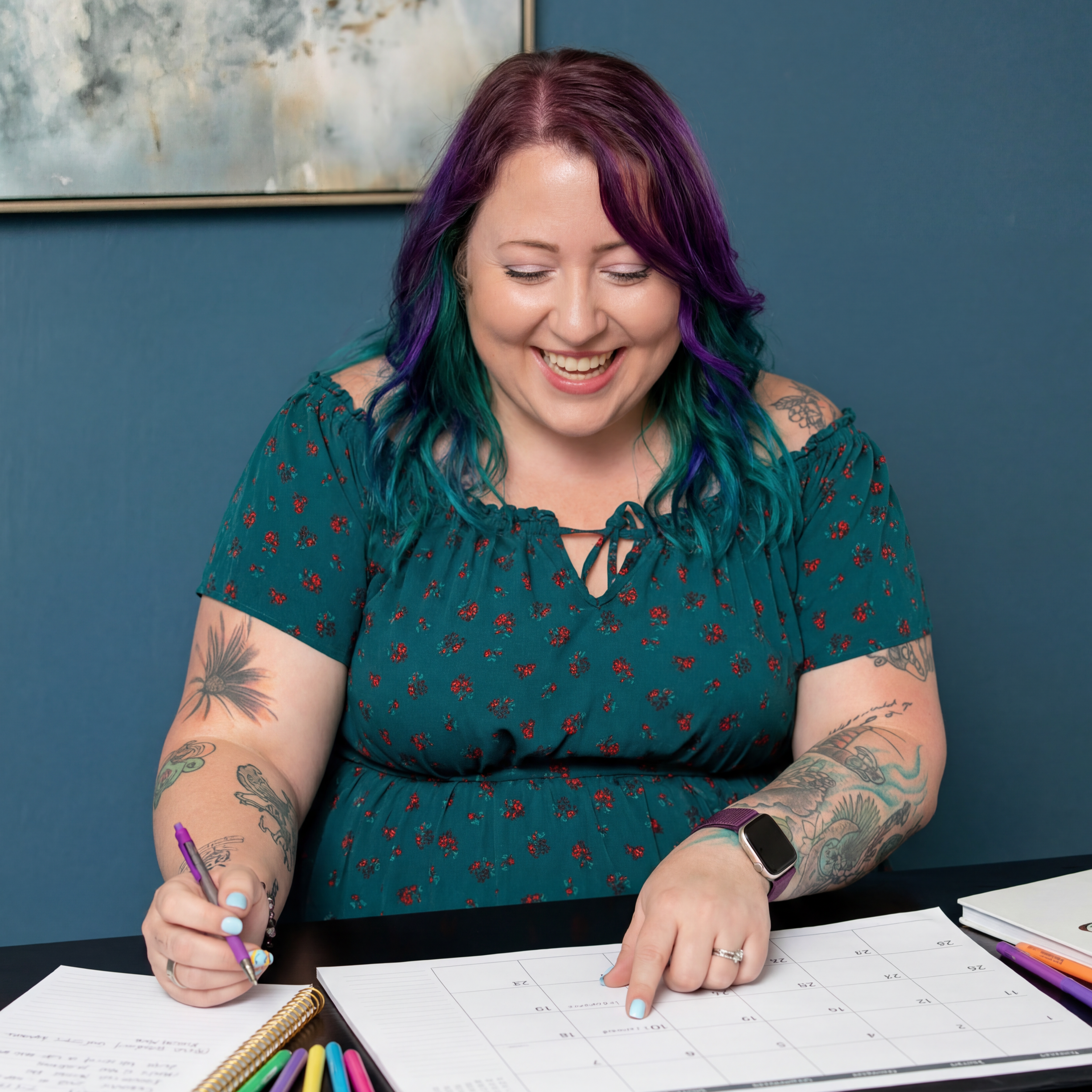 Samantha Willi planning events at her desk with a calendar