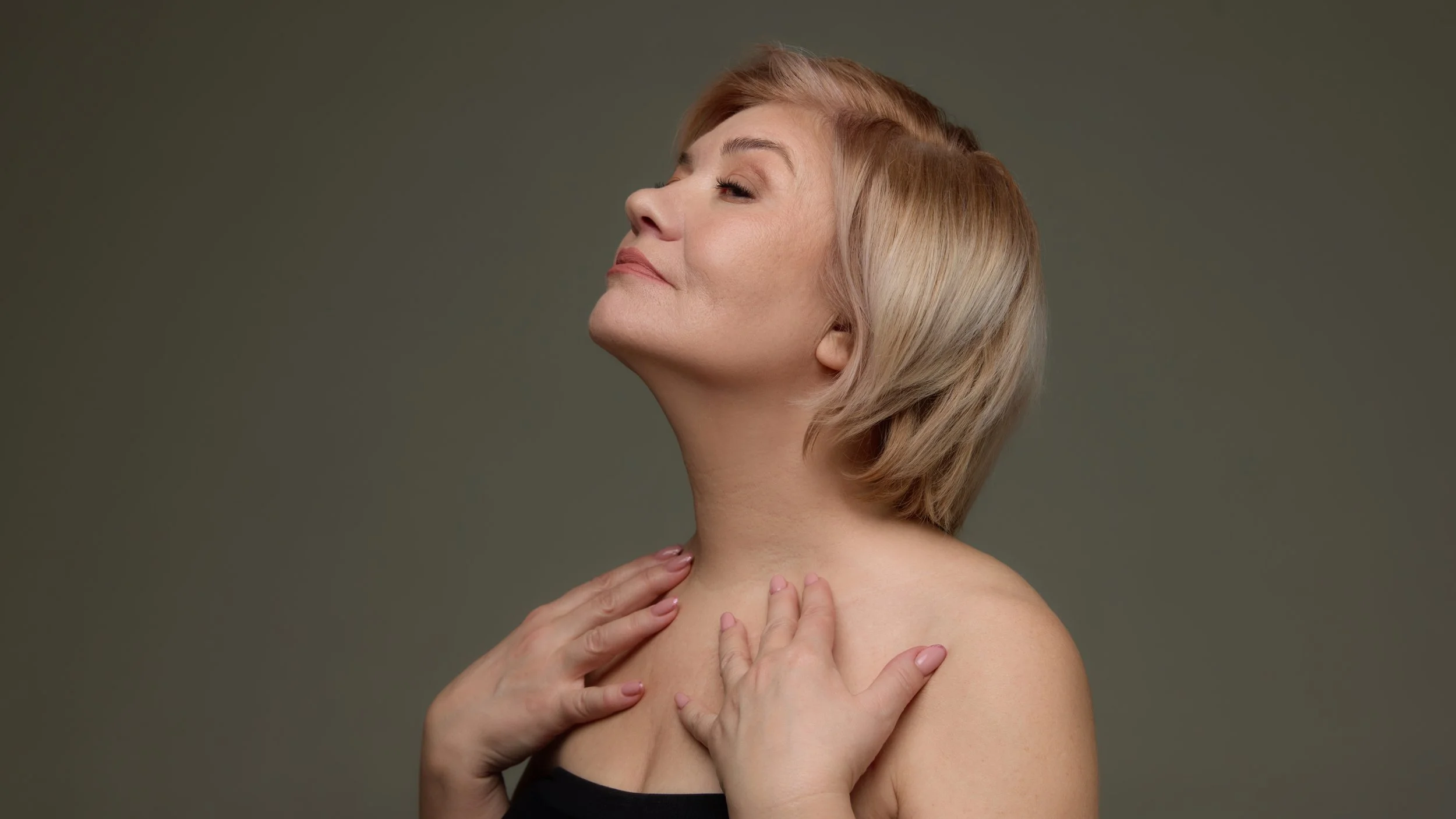 middle aged woman with hands on neck