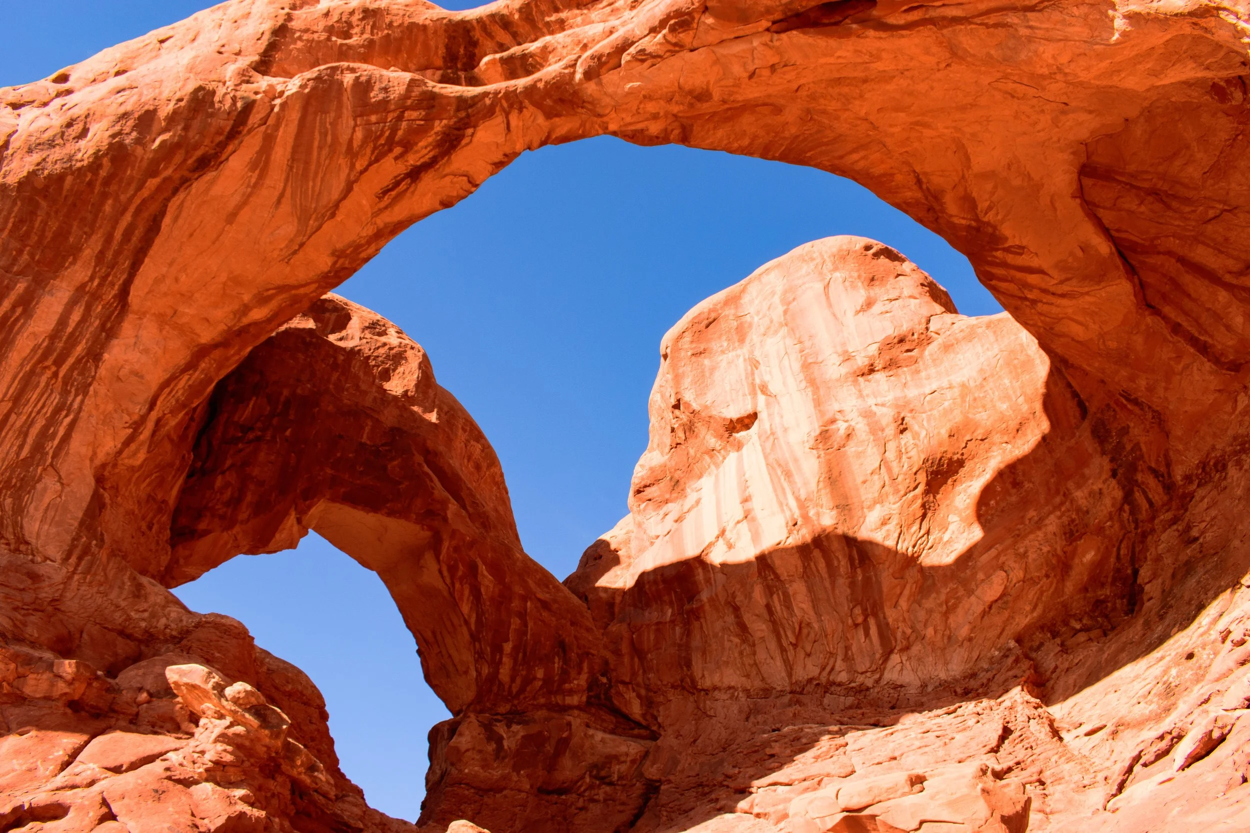 Great overhead arches in Utah with a deep baby blue sky!