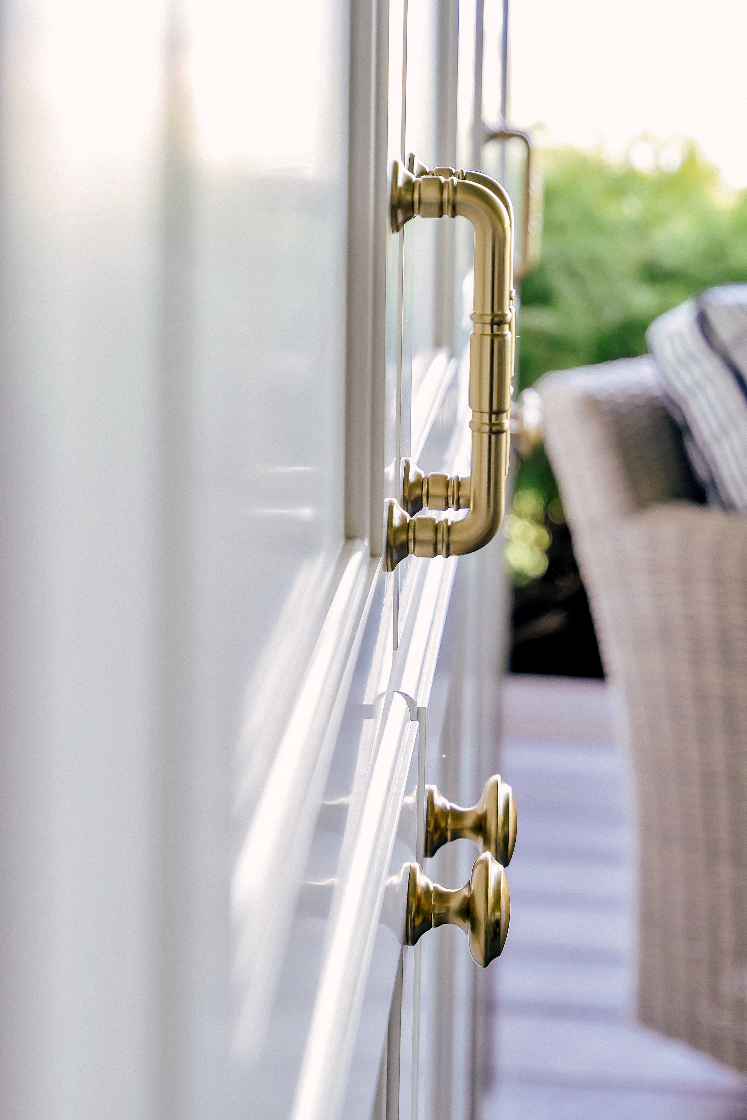 A white custom cabinet with honey bronze hardware accents.
