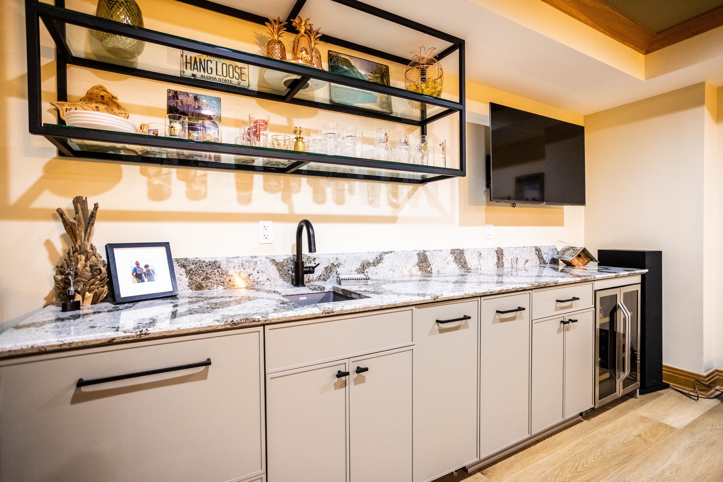 Sleek basement wet bar with Cambria quartz countertops.
