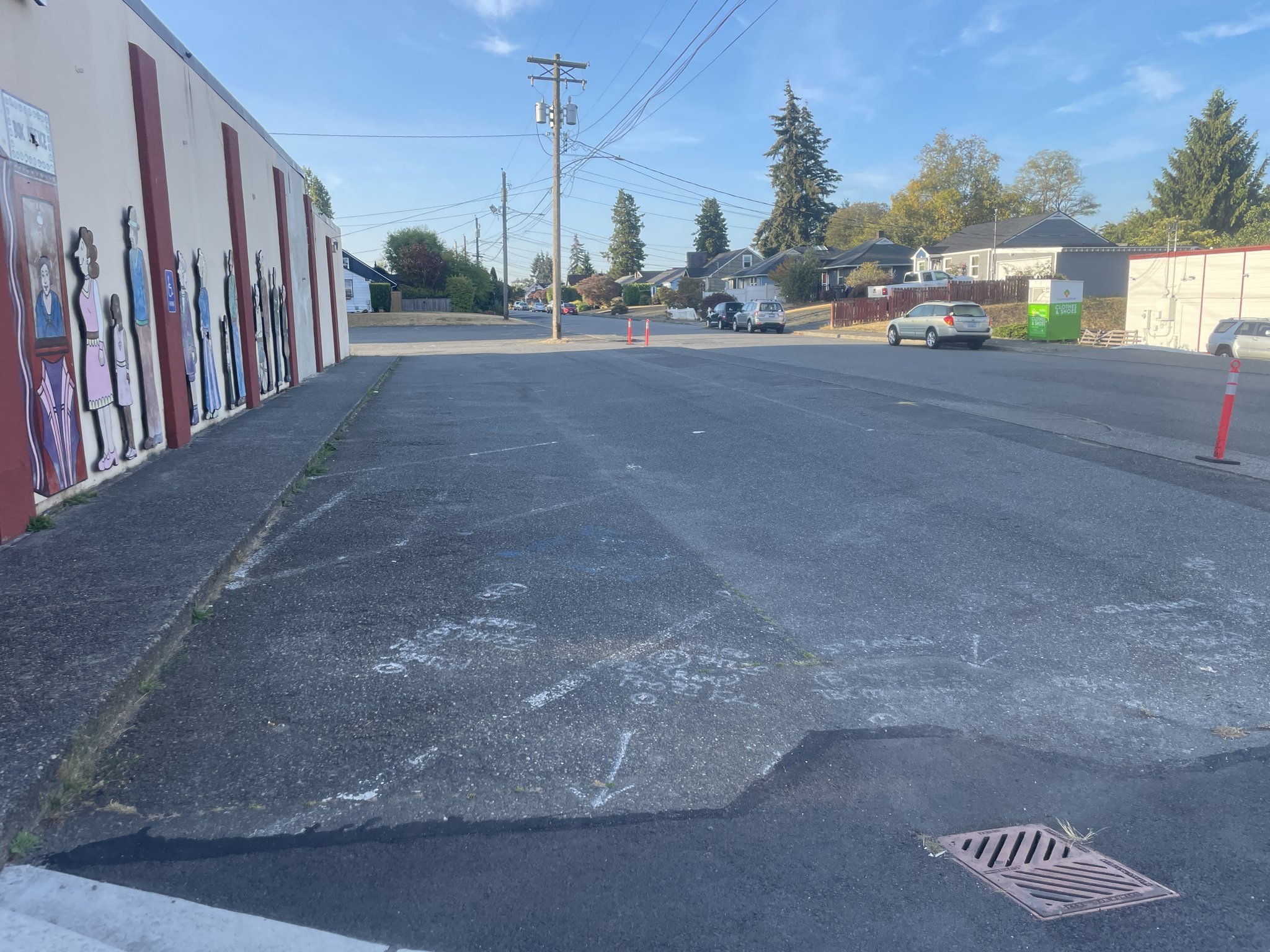 A freshly sealcoated commercial lot with a clean, even black finish along the building wall.