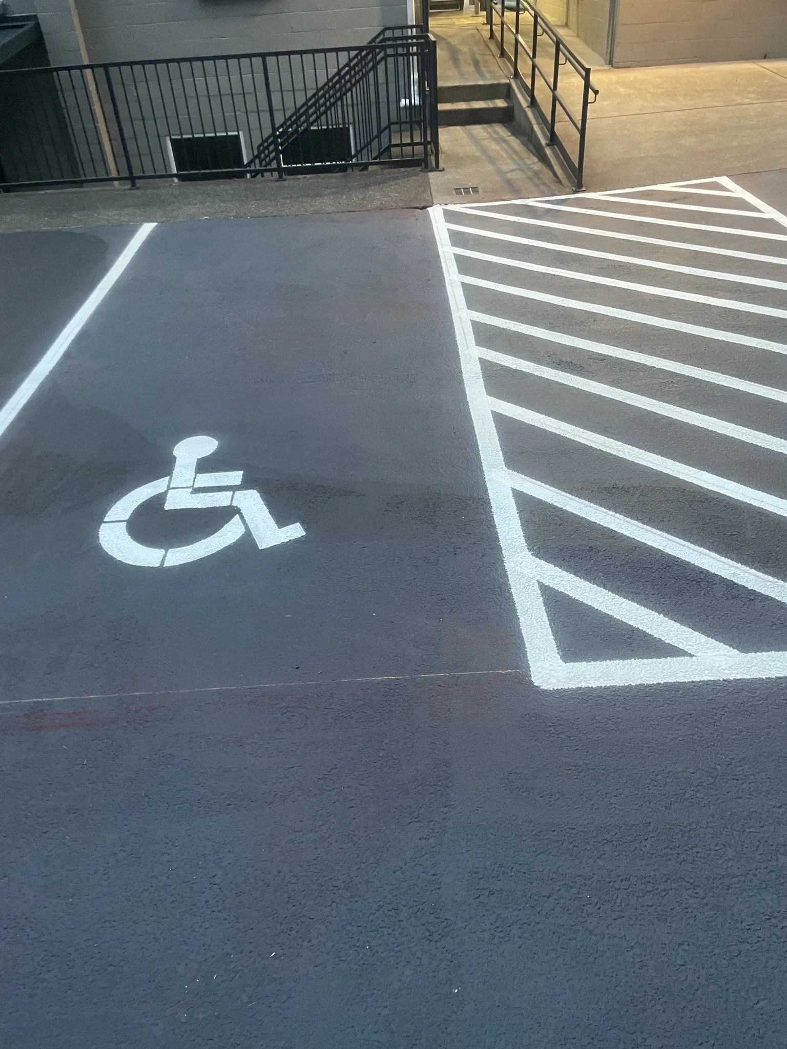 New ADA stall and hatched access aisle, painted to code.