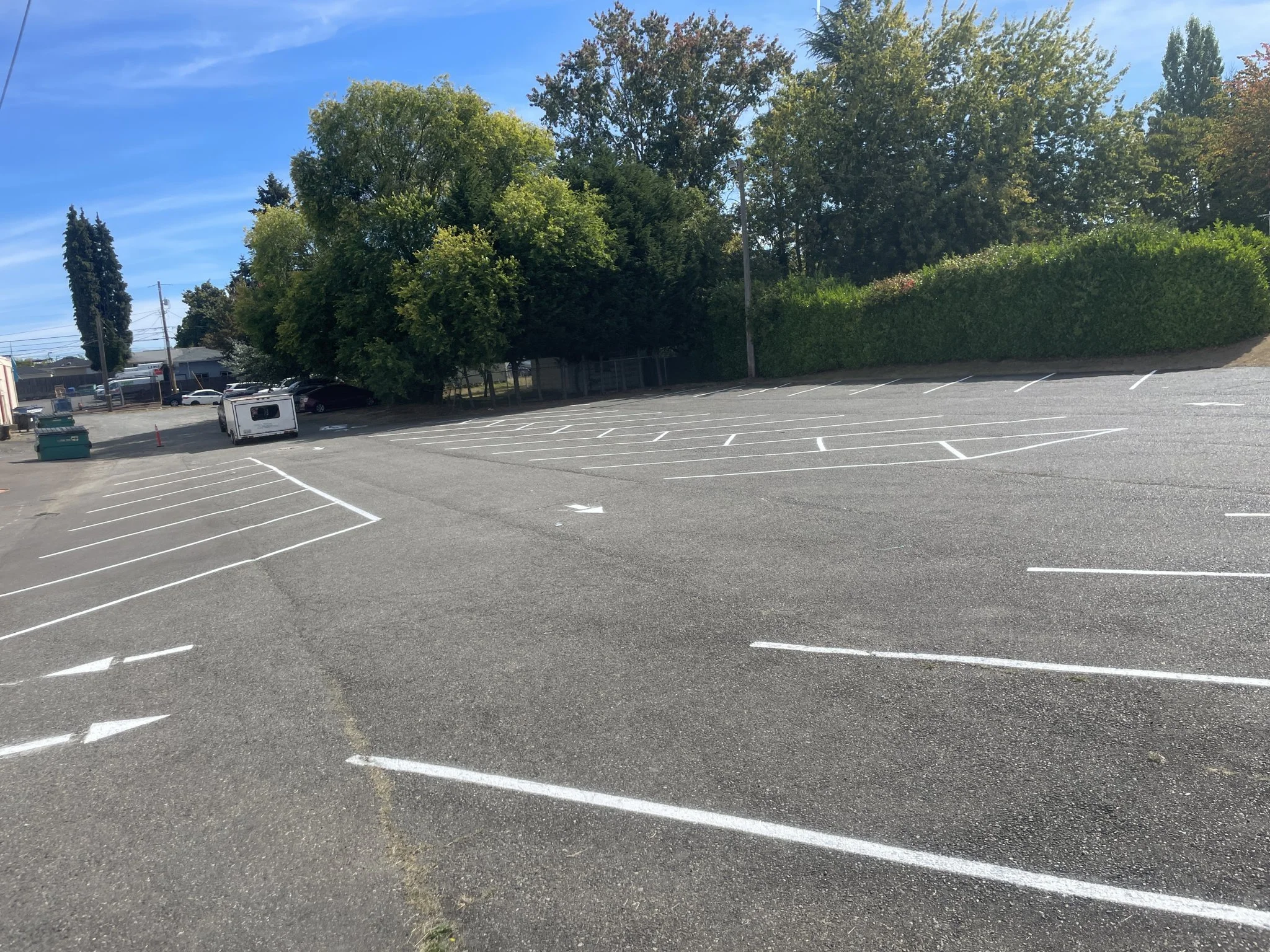 A freshly sealcoated lot with bright new parking lines and directional arrows.