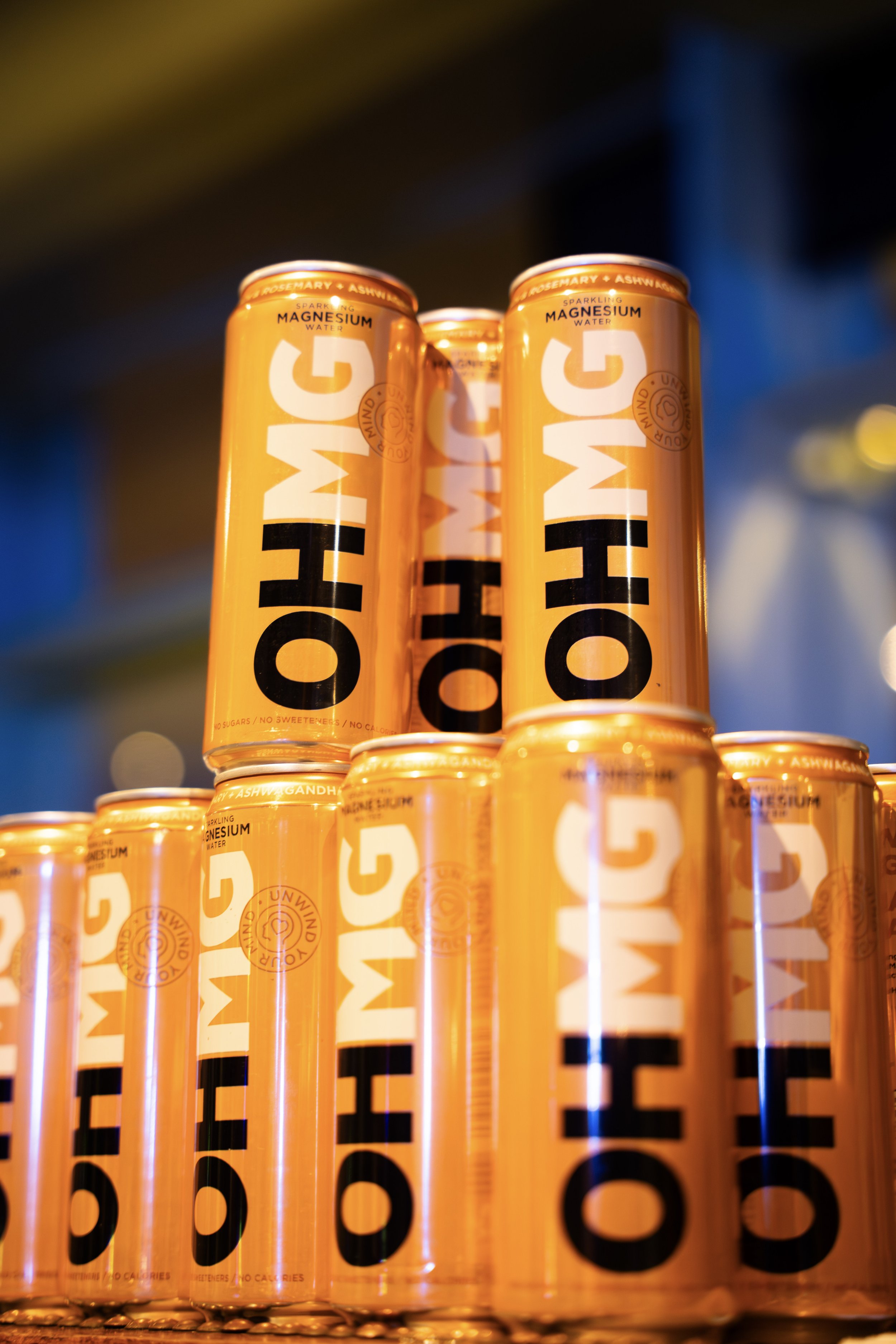 Close-up photo of multiple orange cans stacked in a pattern, with the brand name 'HOTH' visible on the cans.