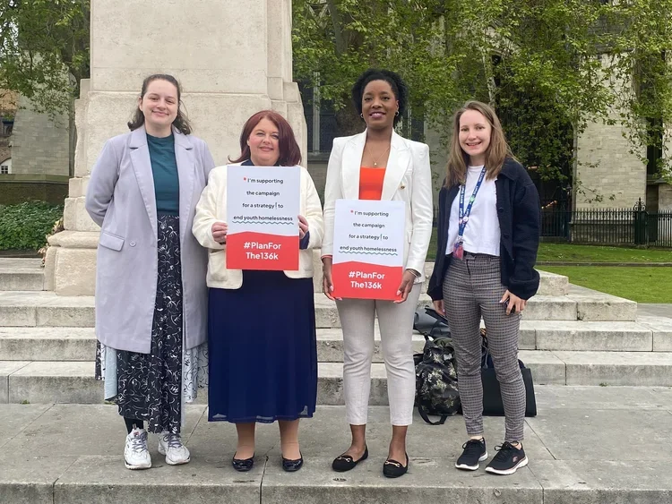 Collective members, young people, and MPs hold ‘#Planforthe136k’ signs