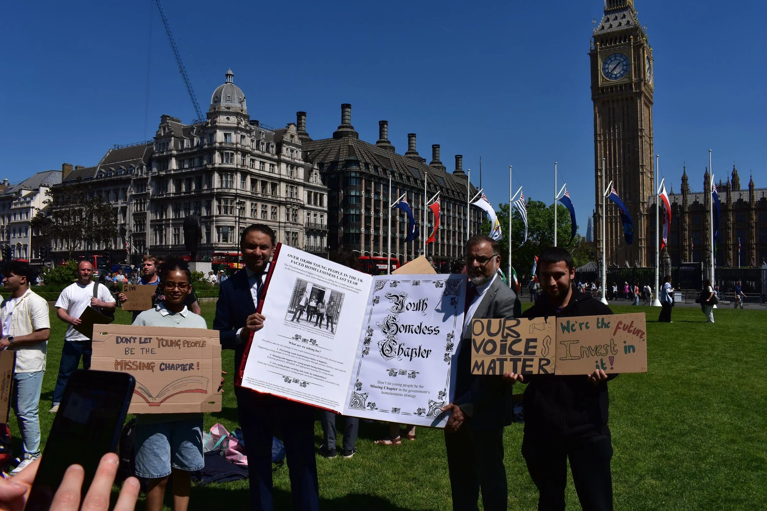  MPs and young people holding the Youth Chapter prop book outside Parliament 