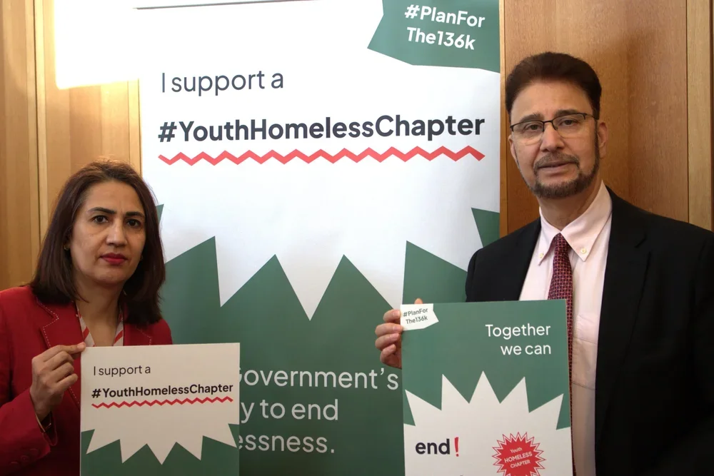 Afzal Khan MP and a member of the House of Lords hold signs in support of the #Planforthe136K