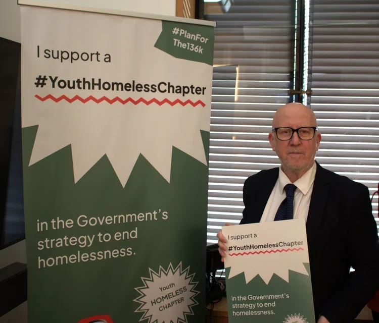 Andy McDonald MP holding up a sign in support of the #Planforthe136K