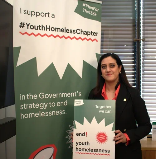 Kirith Entwistle MP holding a sign in support of the #Planforthe136K