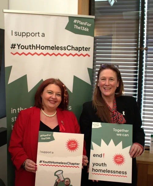 Paula Barker MP and another MP hold signs in support of the #Planforthe136k