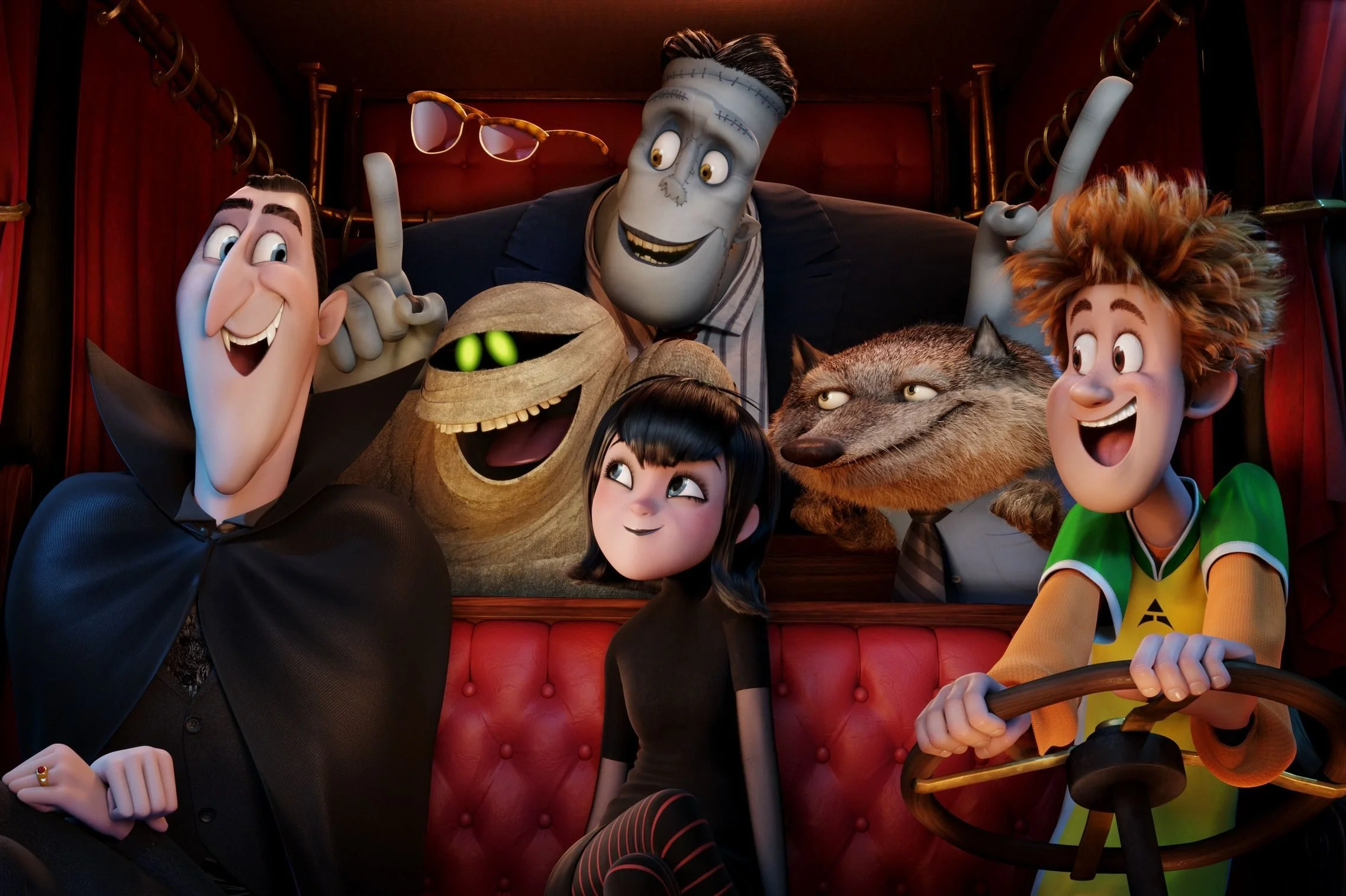 Animated characters from the movie 'Hotel Transylvania' on a roller coaster ride inside a theme park. The characters are smiling and enjoying the ride.