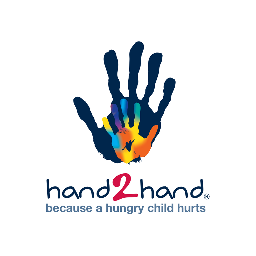 A dark blue handprint with a smaller rainbow-colored handprint inside it. Below the handprints, the text reads "hand2hand" with the number 2 in red and the rest in dark blue. Underneath, it says "because a hungry child hurts" in smaller dark blue font.