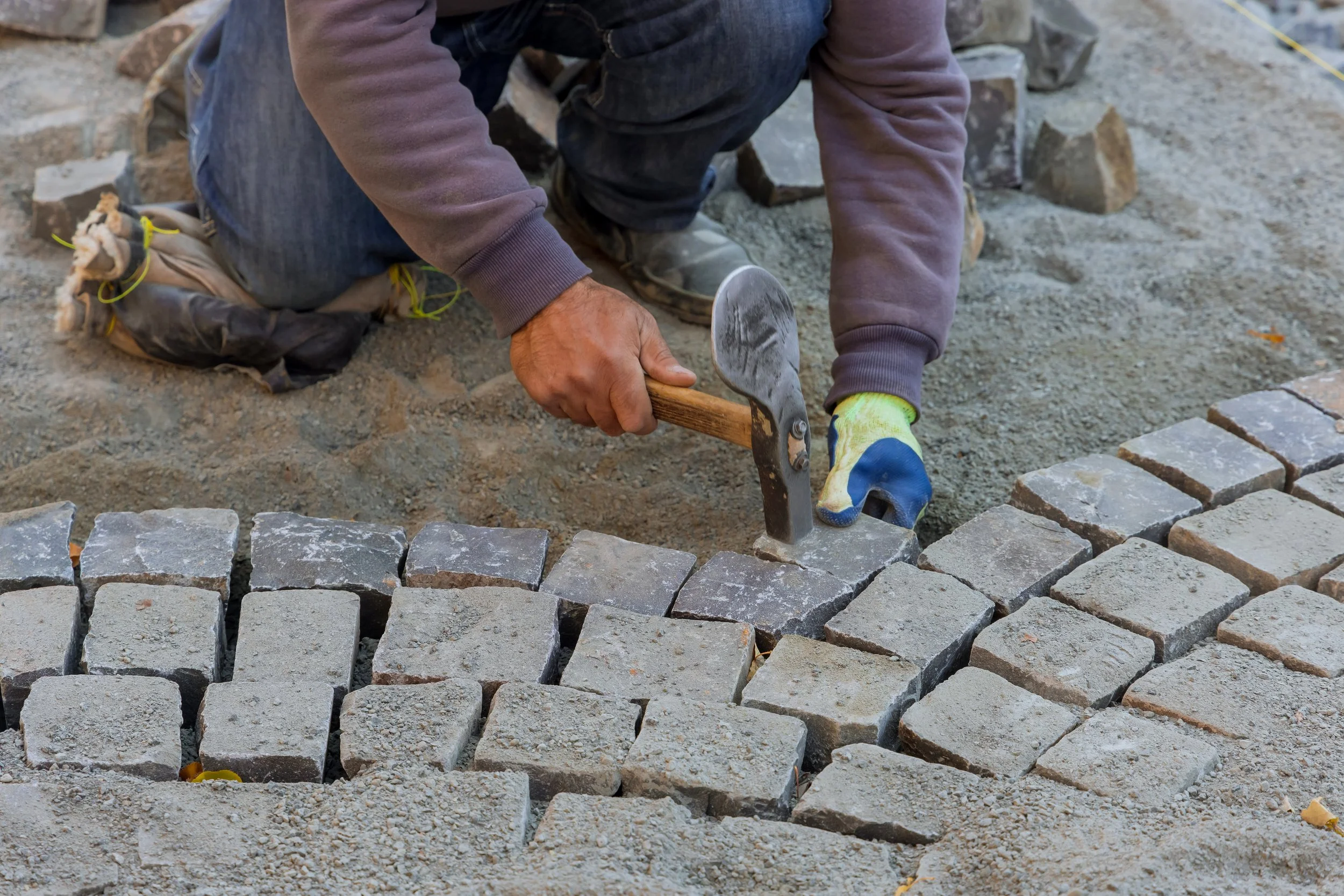 paving-pavement-with-granite-stones-workers-using-industrial-cobblestones-paving-road.jpg