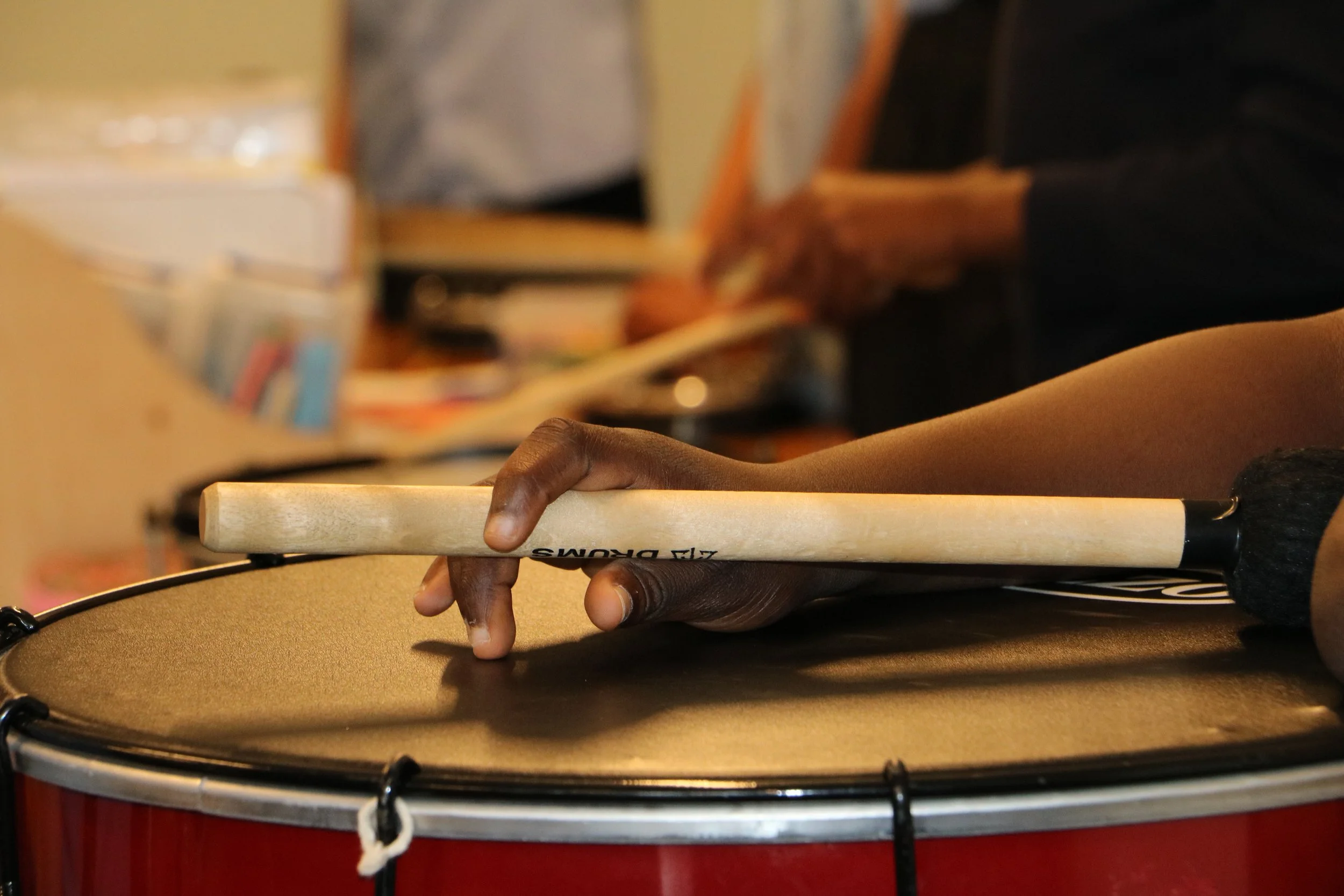 Drumstick hitting a drum