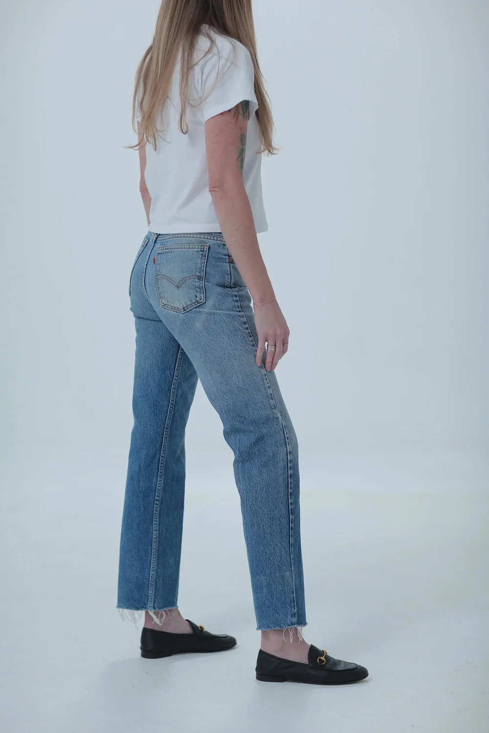 Levi's 505 medium wash, fitted in hips with a little room in waist, side view