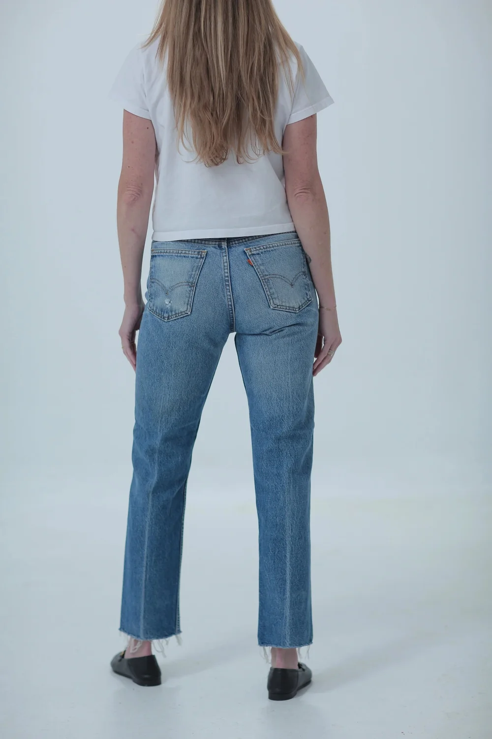 Levi's 505 medium wash, fitted in hips with a little room in waist, rear view
