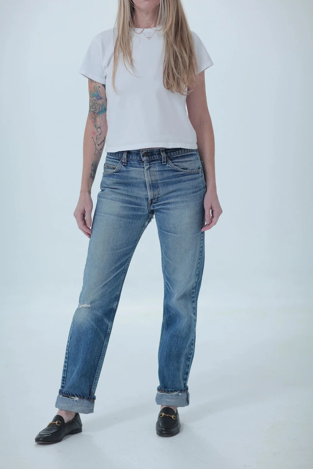 Levi's 505 light medium wash, distressed, boyfriend fit worn cuffed, front view with hip leaning