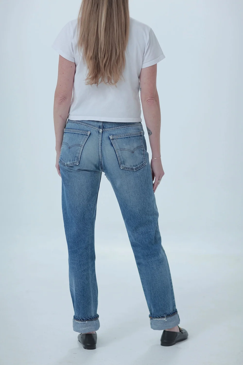 Levi's 505 light medium wash, distressed, boyfriend fit worn cuffed, rear view