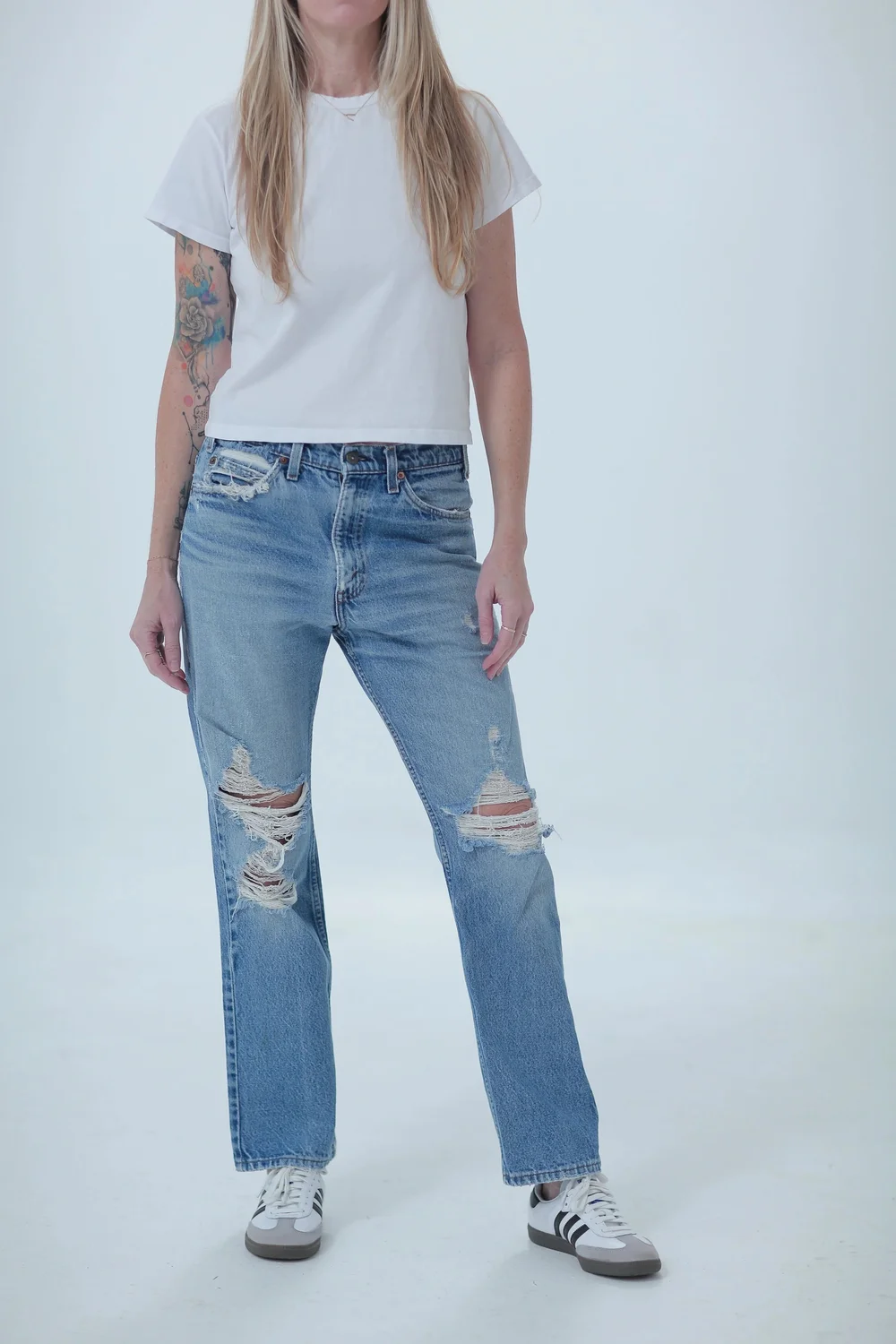 Levi's 509 light medium wash, distressed, boyfriend fit, front view with hip leaning