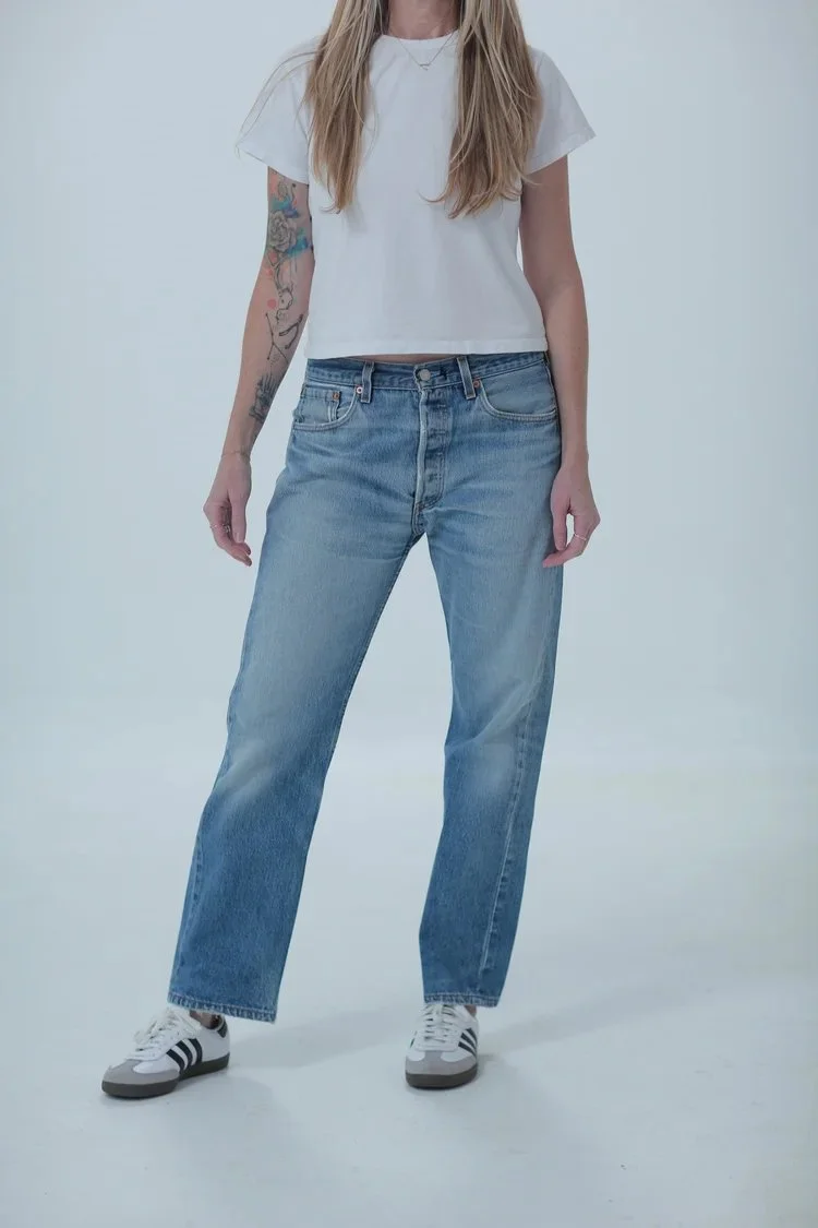 Levi's 501 light medium wash, boyfriend/oversized fit, front view with hip leaning