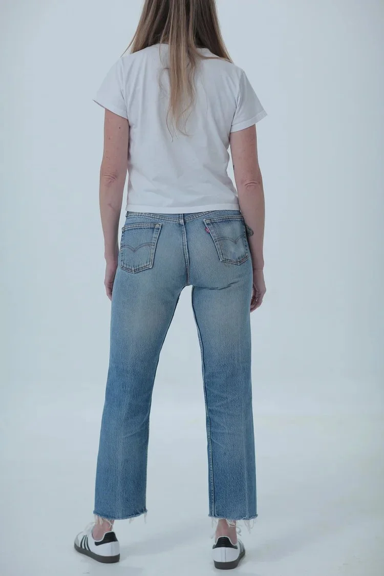 Levi's 501 classic medium wash, fitted with cropped raw hem, rear view