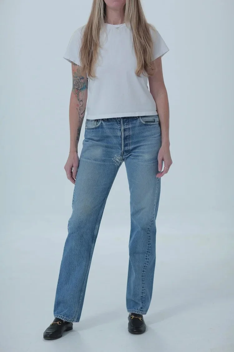Levi's 501 light medium wash, fitted with a little room, full length, front view with hip leaning