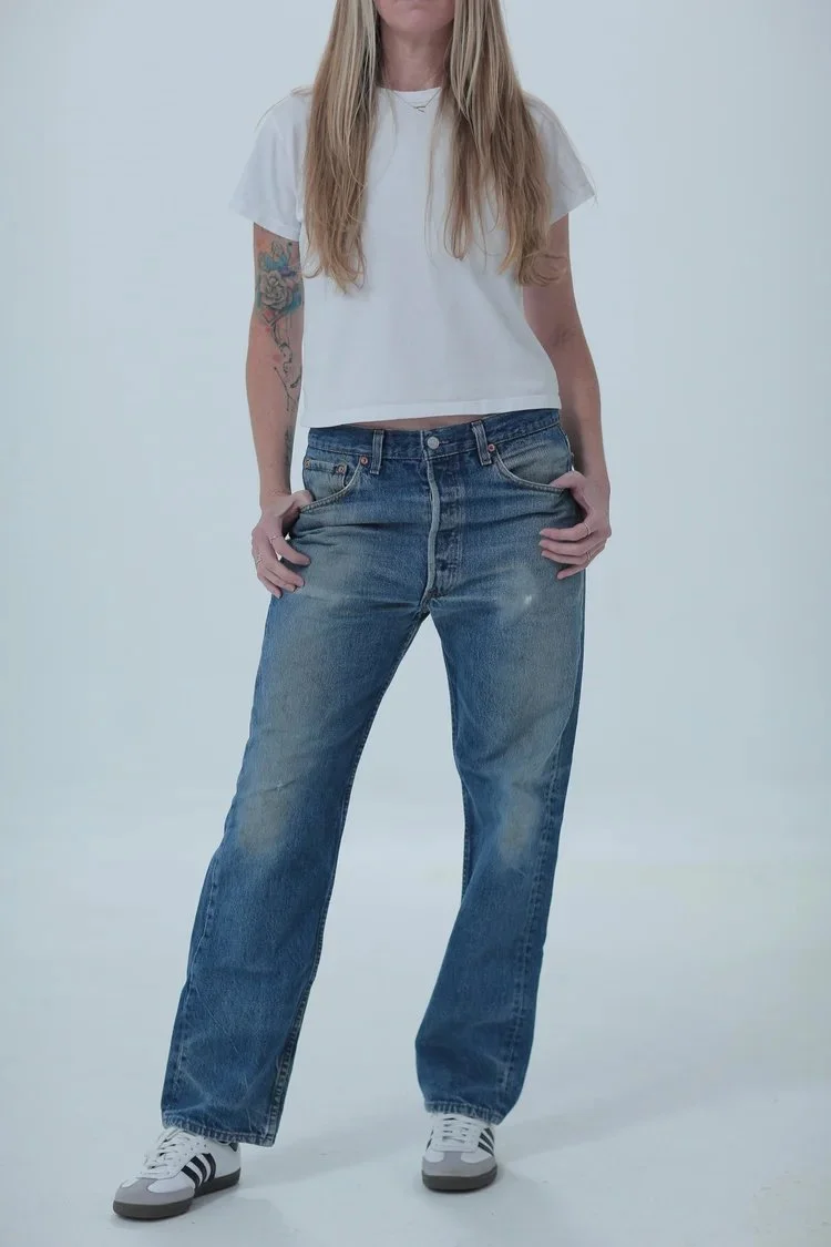 Levi's 501 medium dark wash, boyfriend/oversized fit, front view with hip leaning