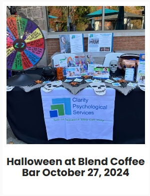 A table decorated for Halloween with a wheel of fortune, brochures, skull decorations, and a banner for Clarity Psychological Services at Blend Coffee Bar, October 27, 2024.