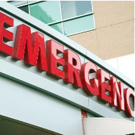 Hospital emergency sign in red letters outside a medical building