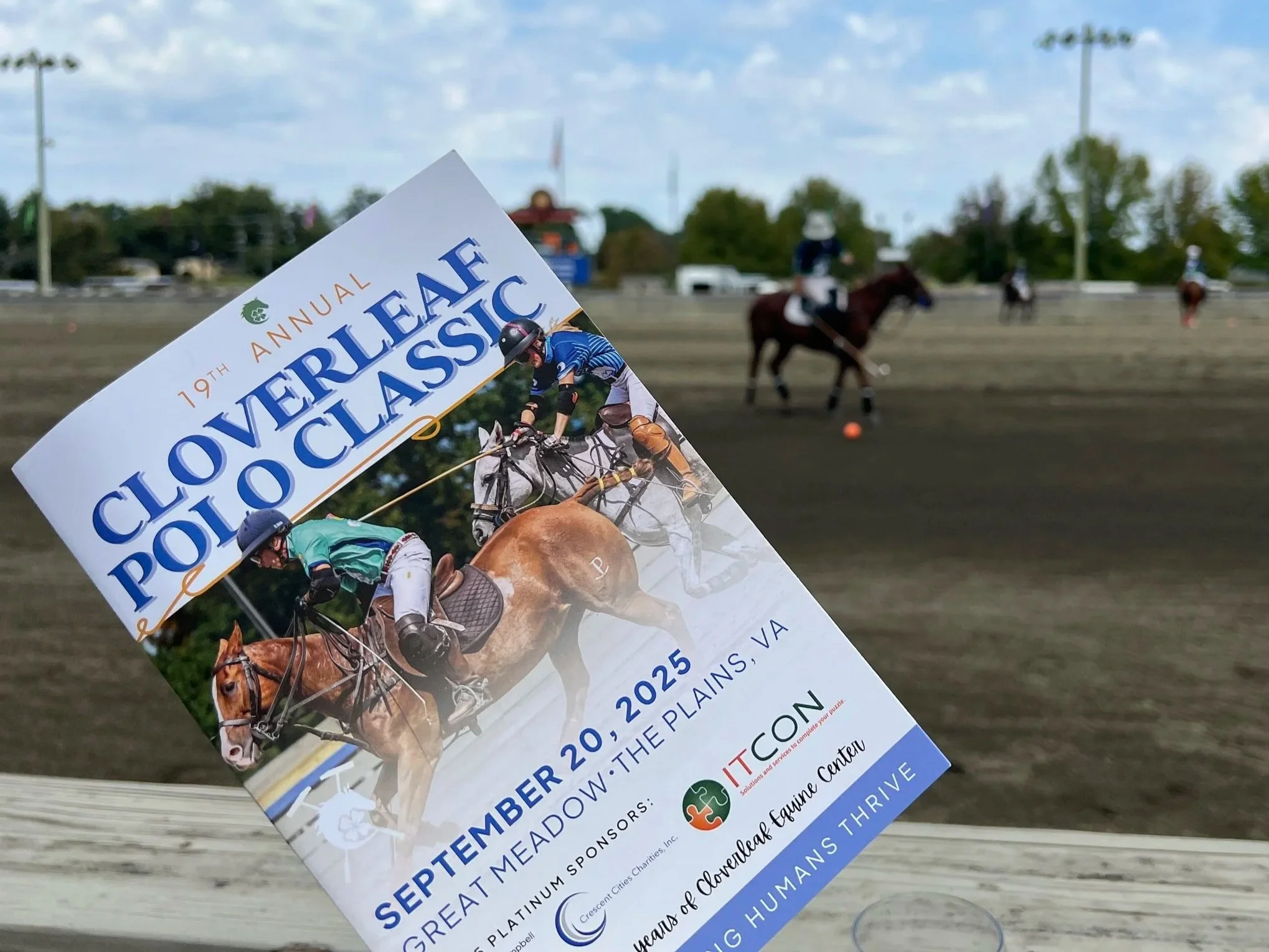 Close-up of a flyer for a polo event, featuring an image of polo players on horseback, with a polo field and players in the background.