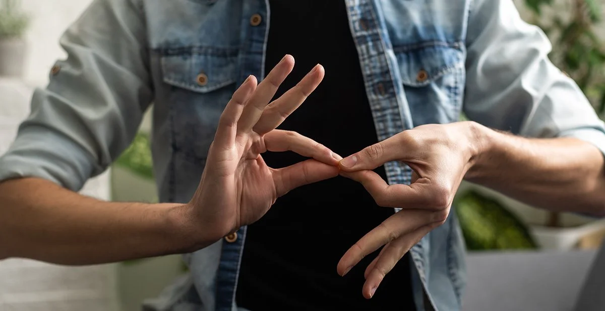 Person using ASL with their hands