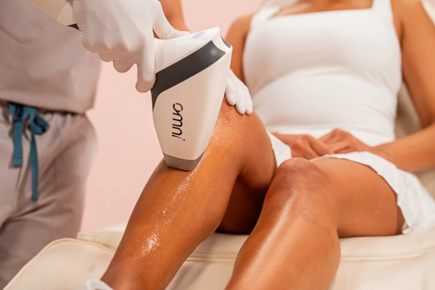 A person receiving a laser treatment on their thigh in a medical setting