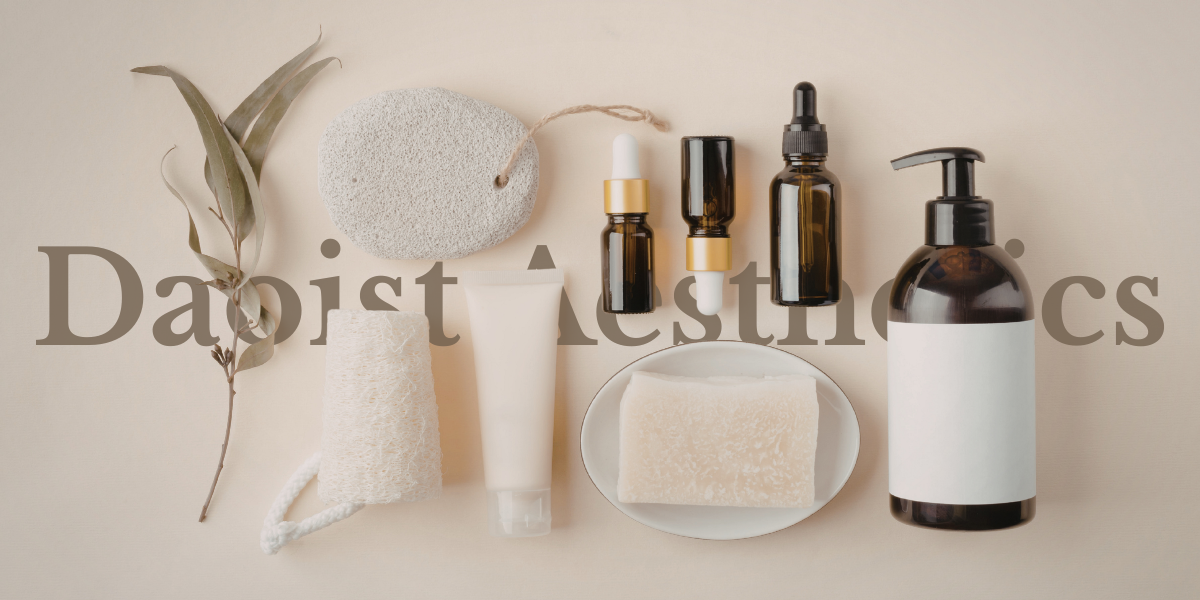 Skincare and aesthetic products arranged on a light background, including leaves, sponges, dropper bottles, a tube, a soap bar, and a pump dispenser.