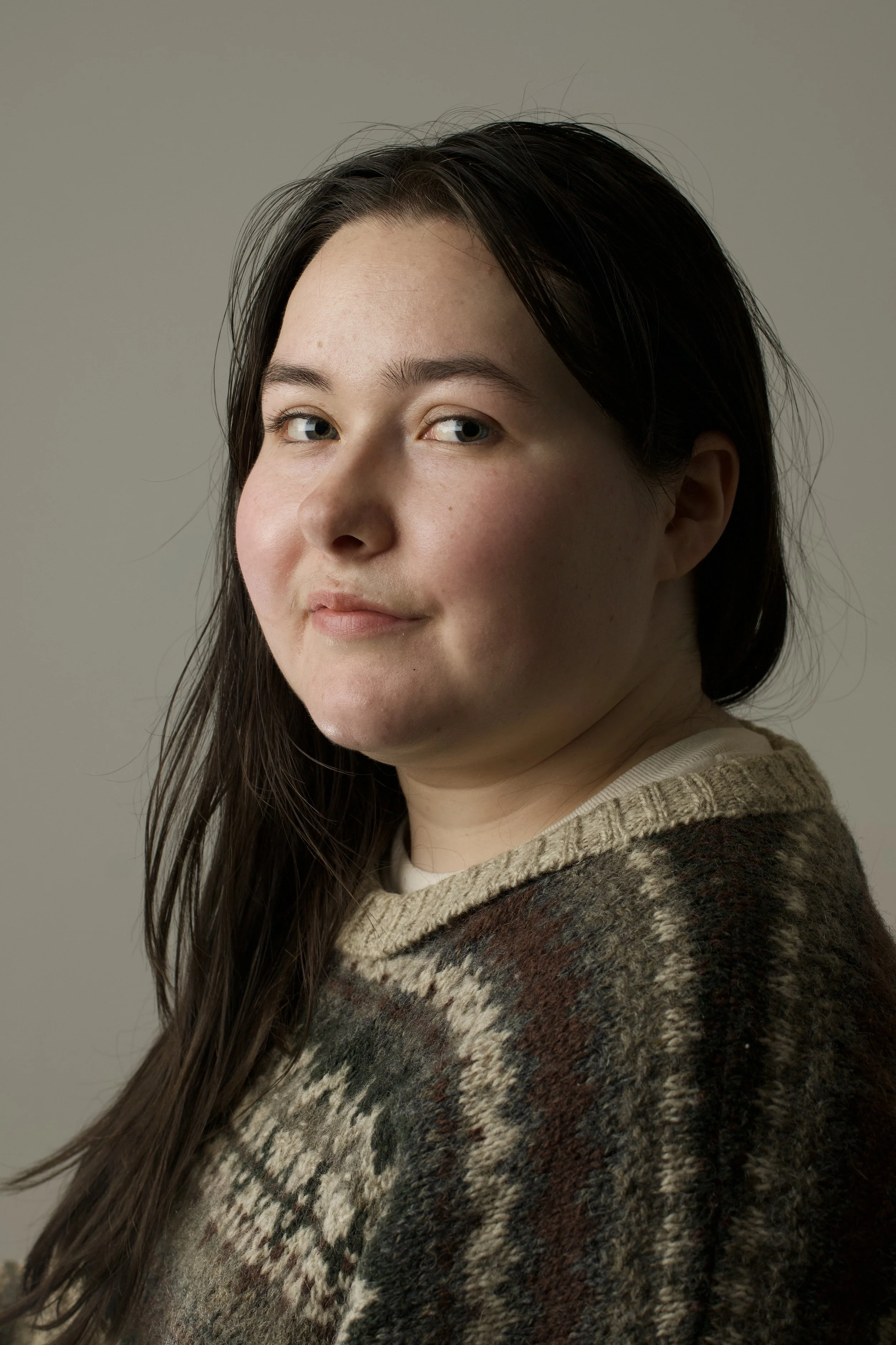head shot of woman in a neutral brown knit sweater
