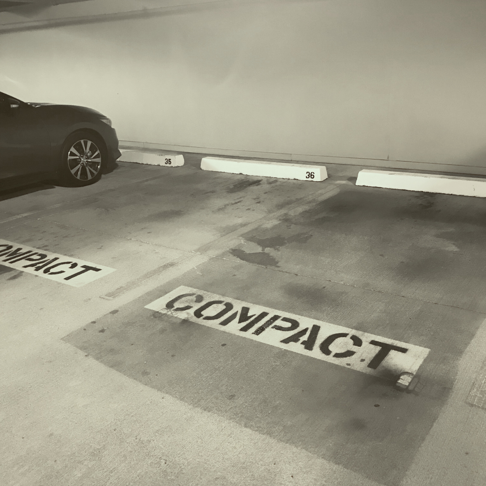 Parking garage power washing was completed around parked vehicles in Arizona parking garage.