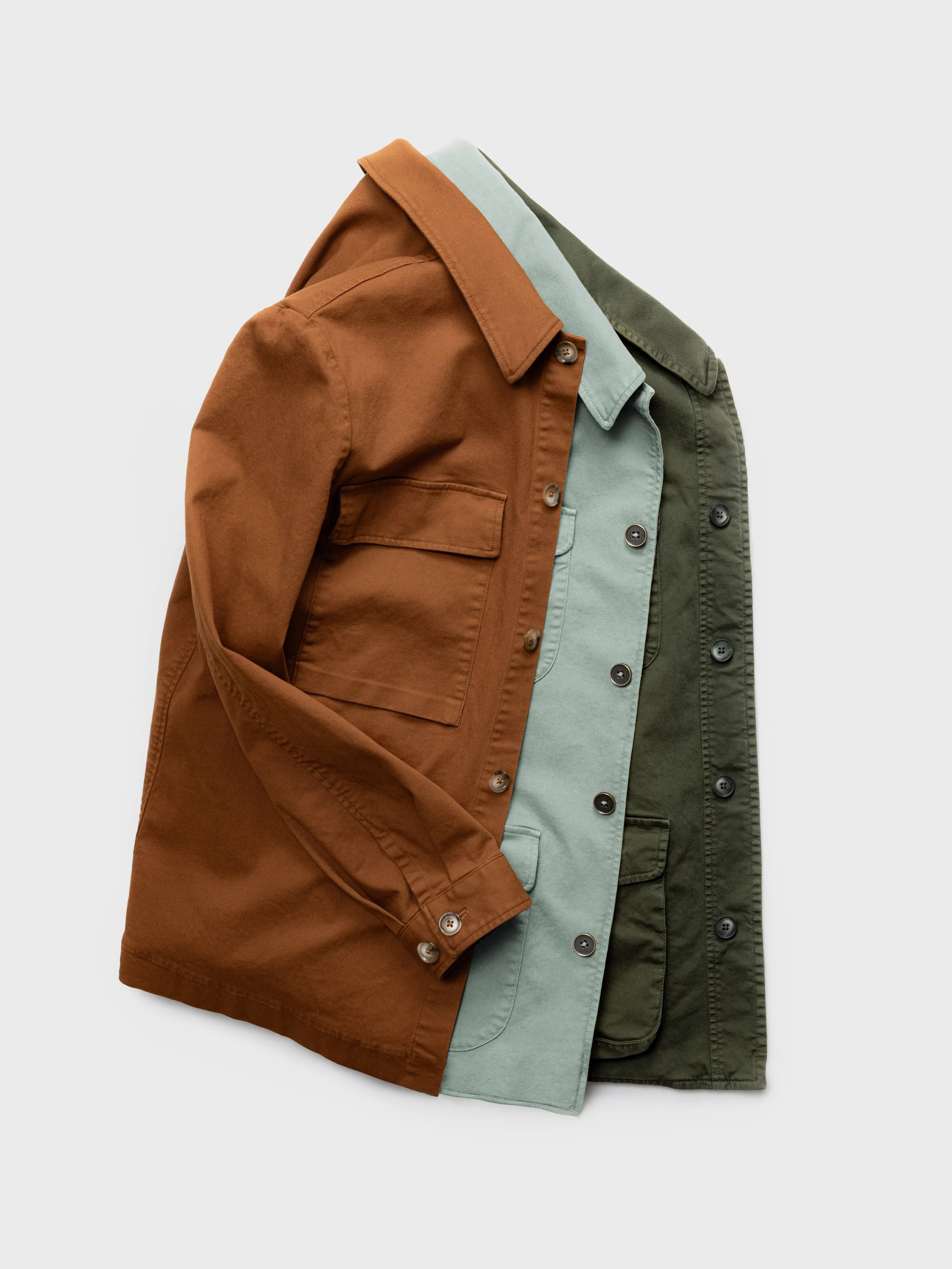 Three layered casual jackets in brown, light green, and dark green colors, displayed on a plain background.