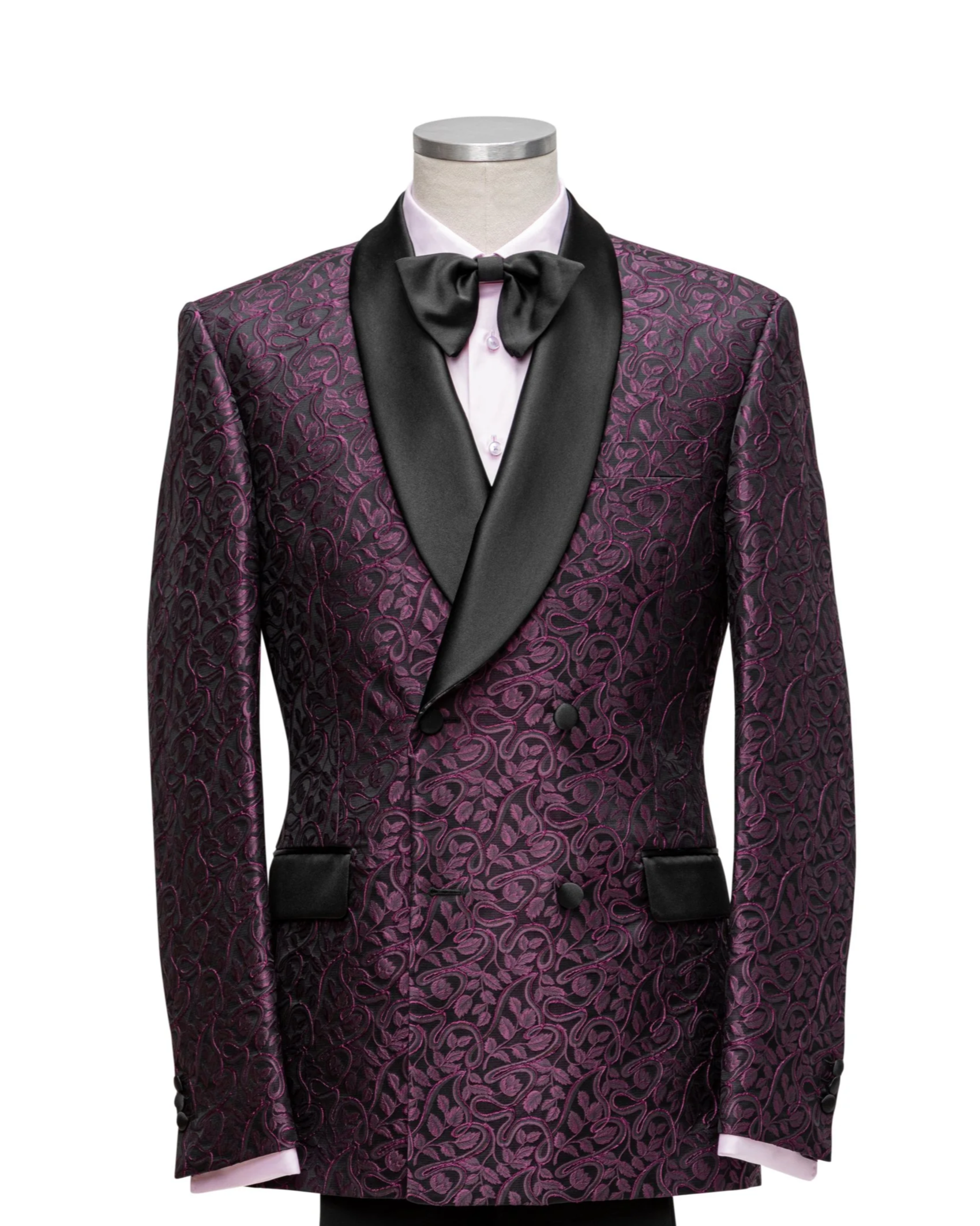 A  formal dinner jacket with a purple and black patterned blazer, black satin lapel, white shirt, and black bow tie displayed on a mannequin.