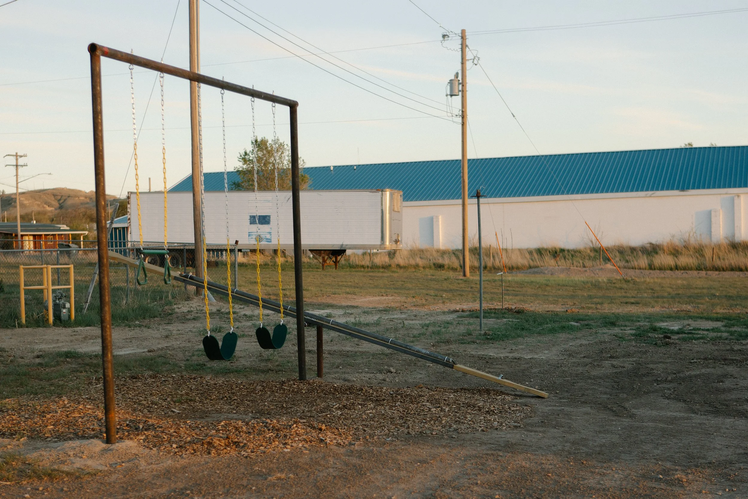 Playground with swings and teeter totter for kids to play at while staying at the RV Park in Chadron