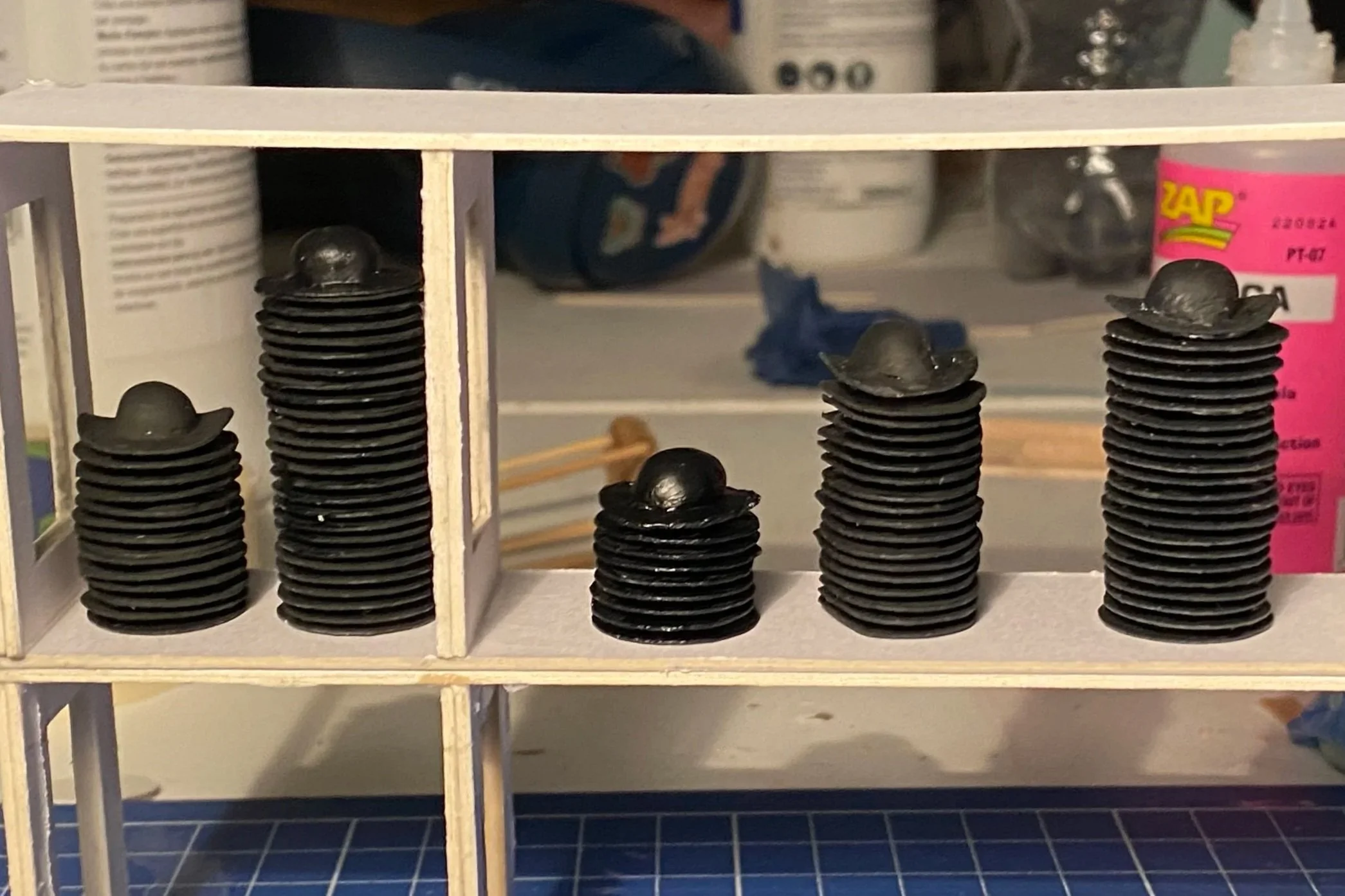 The plain hats, covering the shelfs, ready to become extravagant hats