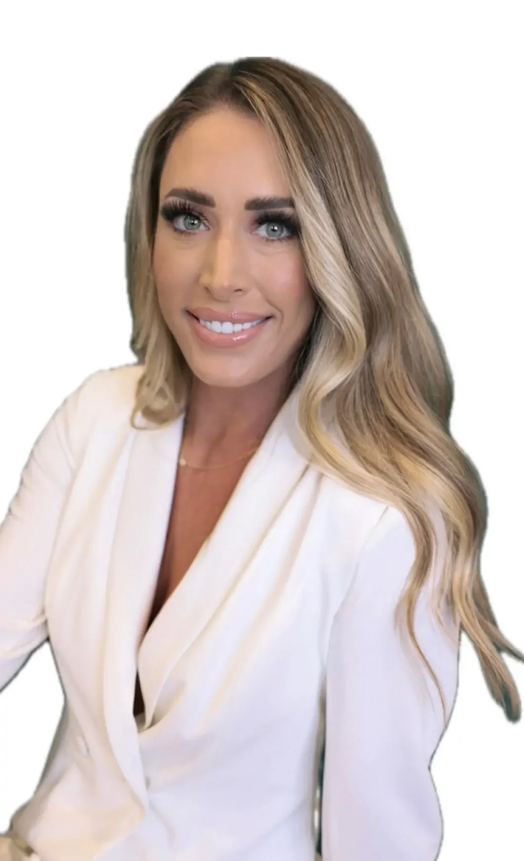 A woman with long wavy blonde hair, blue eyes, and a bright smile wearing a white blazer.