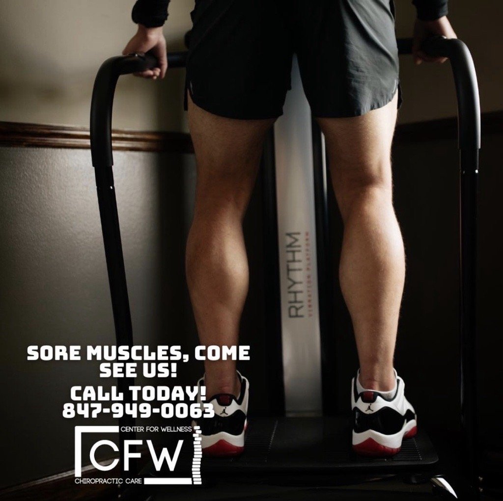 A person standing on a treadmill, wearing athletic shoes and shorts, holding onto the treadmill handles, with a promotional message for muscle soreness relief from Center for Wellness Chiropractic Care. The message includes a phone number and a call to action to see them for sore muscles.