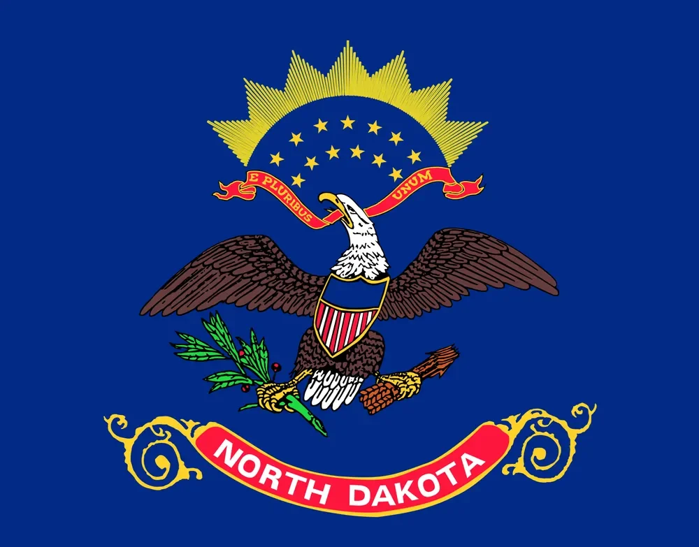 Seal of the state of North Dakota featuring a tree, bison, farmer plowing, and landscape, with stars and inscriptions.