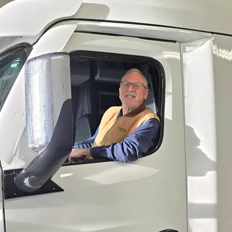 Candidate Vern Thompson driving truck.