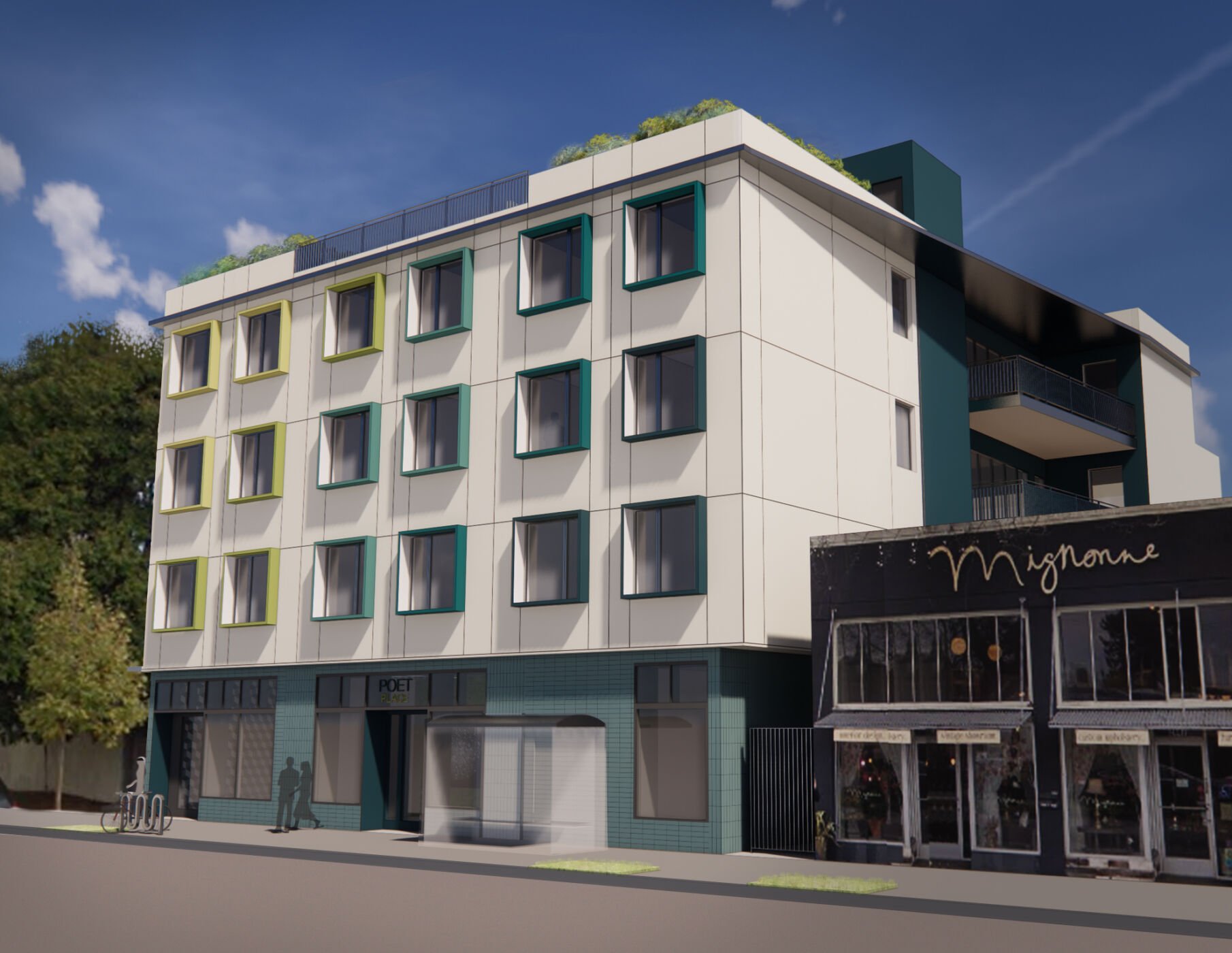 A modern multi-story building with a white facade, featuring square windows with green and black frames. The ground floor has commercial spaces, including a store with a black and gold sign that says "Mignon". There are two people walking on the sidewalk and a bike rack in front of the building. Trees are visible in the background, and the sky is clear with a few clouds.