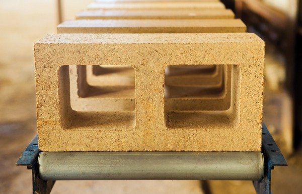 A row of concrete blocks on a metal roller at a construction site.